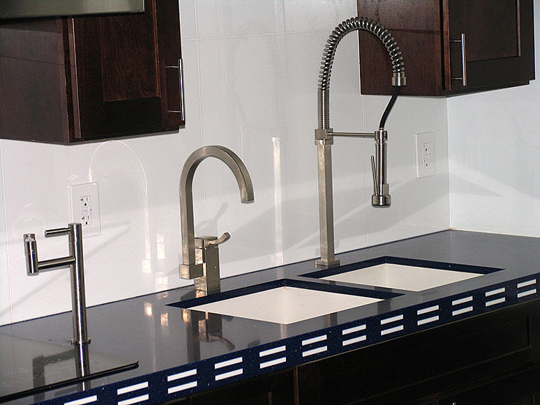 marble kitchen counter with ceramic tile wall